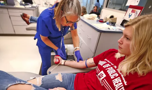public health student giving blood