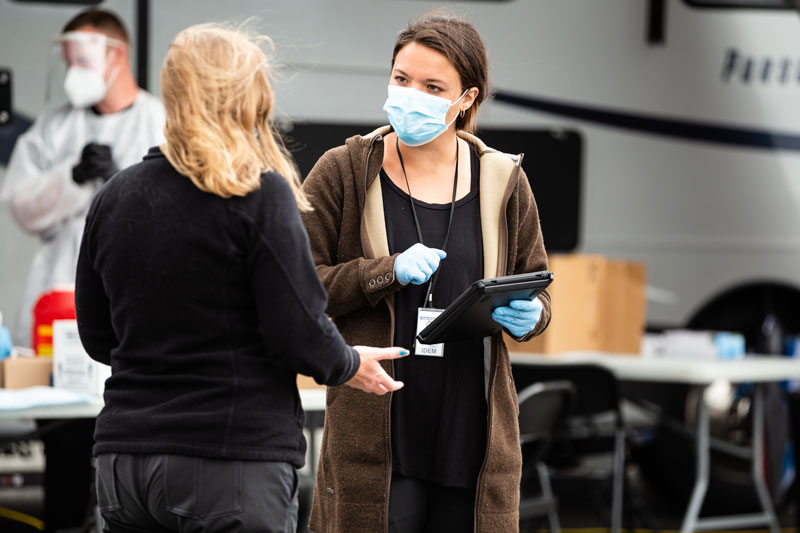 community worker with mask speaking to patient