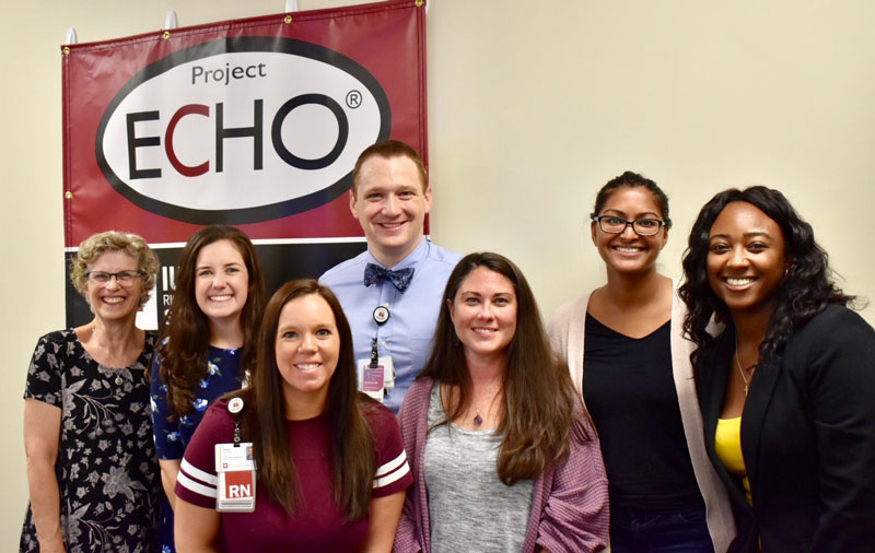 7 people standing in front of project echo sign