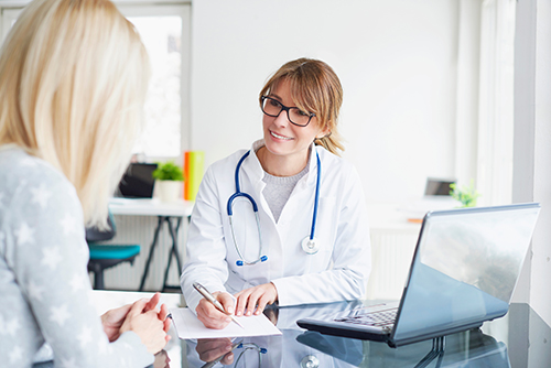 physician going over paperwork with patient