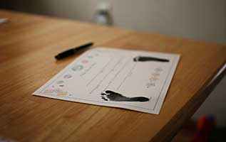 baby's birth certificate sitting on a table